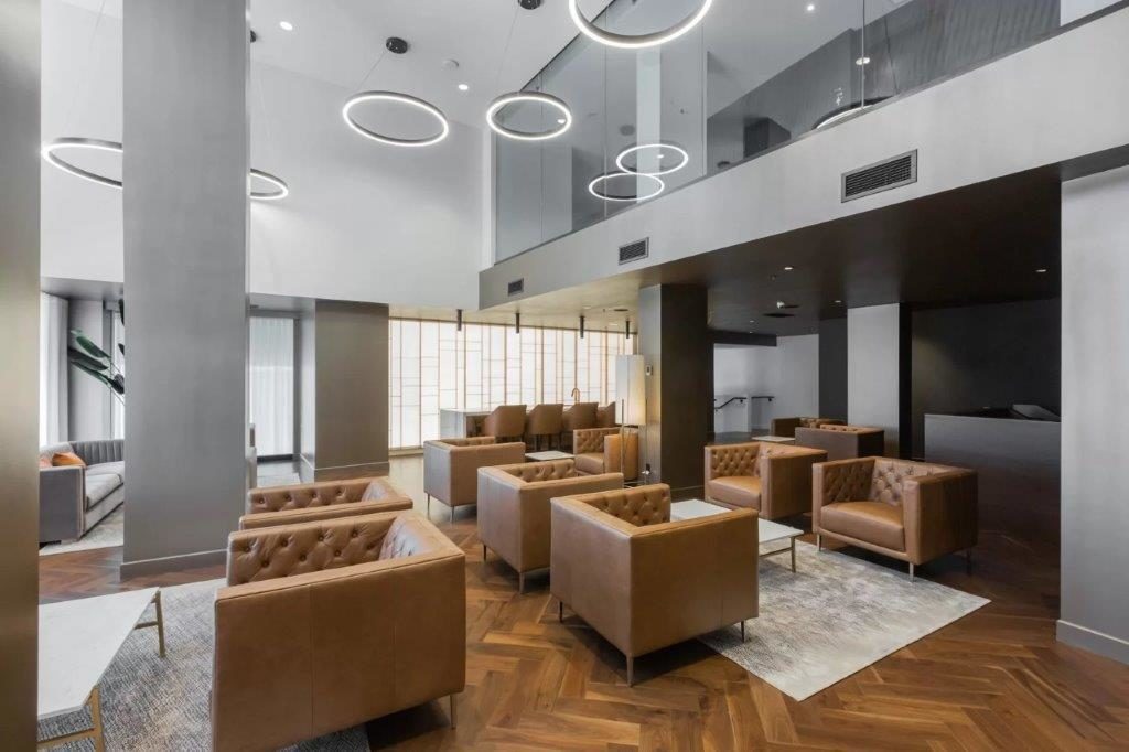 Modern lounge with brown leather chairs.